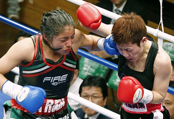 Ibeth Zamora of Mexico, left, punches Naoko Shibata of Japan in the fourth round of their 10-round playoff boxing bout for WBC women`s light flyweight world title at Korakuen Hall in Tokyo.