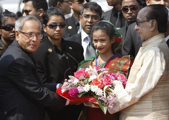 Visiting Indian President Pranab Mukherjee, left, is presented with flowers as he is received by his Bangladeshi counterpart, Zillur Rahman, right, upon his arrival at the airport in Dhaka.