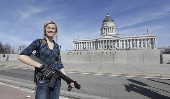 Gun rights activist Darci Lund, 20, carries her rifle during a rally in support of the 2nd Amendment at the Utah State Capitol in Salt Lake City.
