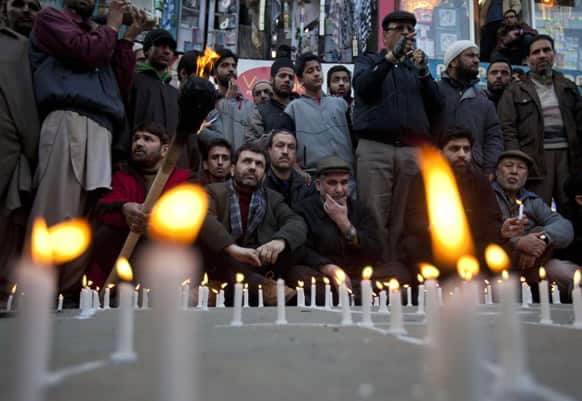 Leaders and activists of Jammu Kashmir Liberation Front (JKLF) participate in a candle light protest in Srinagar.