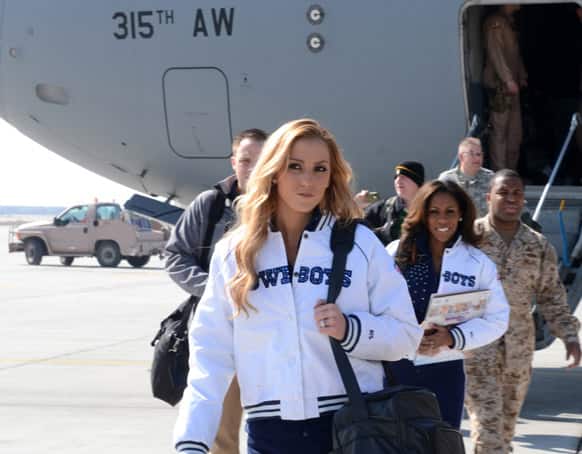 Dallas Cowboys Cheerleaders Cassie Trammell (left) and Jackie Bob, along with Peyton Manning, Curt Schilling, Austin Collie and Steven Jackson arrive at Bagram Airfield, Afghanistan, to entertain the troops with a USO tour.