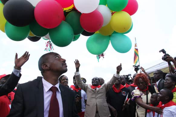 Zimbabwean President Robert Mugabe, centre, releases balloons into the air during celebrations to mark his 89th birthday in Bindura about 100 kilometres north of Harare.