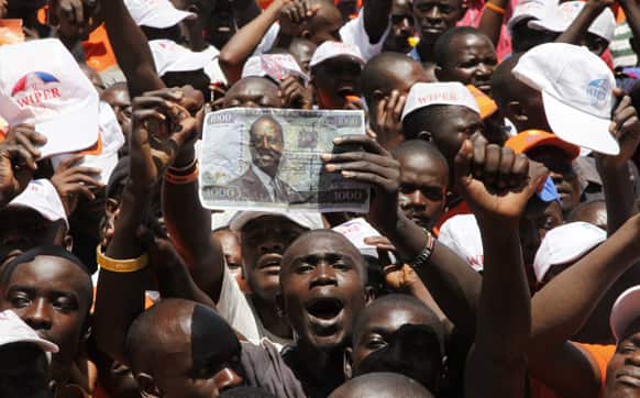 Kenyan Prime Minister and Presidential candidate, Raila Odinga`s supporters show a 1,000 Kenya shillings note featuring the picture of Raila Odinga as they gather at Nyayo National Stadium, Nairobi for the final day of the campaign for the election.