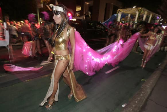 A parade participant trails a pink train to her outfit during Mardi Gras in Sydney, Australia. 10,000 are marching along side 115 floats in the annual parade that celebrates lesbian and gay pride.