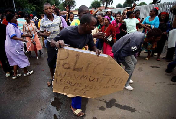 Residents protest the death of Mozambican taxi driver Mido Macia outside a local police station, in Daveyton, near Johannesburg, South Africa.