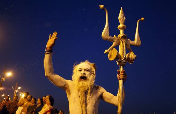 Naked Hindu holy man, performs evening rituals after a holy dip at Sangam, the confluence of the Ganges, Yamuna and the mythical Saraswati River, during the Maha Kumbh festival in Allahabad.