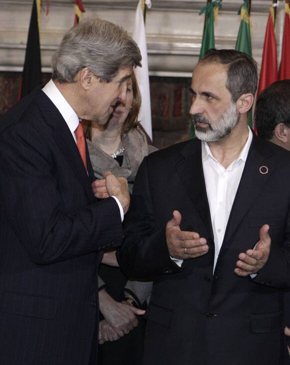 US Secretary of State John Kerry, left, talks to Syrian opposition coalition leader Mouaz al-Khatib, during an international conference on Syria at Villa Madama, Rome.