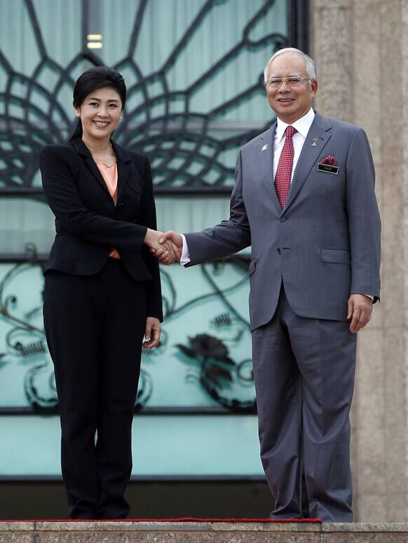 Malaysian Prime Minister Najib Razak greets his Thai counterpart Yingluck Shinawatra during her visit to Putrajaya, Malaysia.