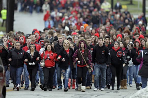 Chardon High School students march to the square in Chardon, Ohio for a memorial ceremony for three classmates who died in a school shooting rampage one year ago.