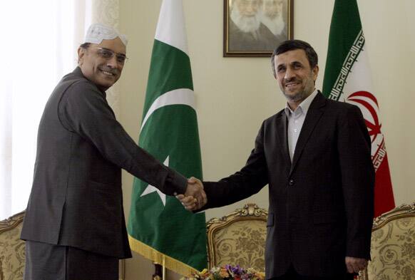 Iranian President Mahmoud Ahmadinejad and his Pakistani counterpart, Asif Ali Zardari, shake hands for photographers at the start of their meeting in Tehran, Iran.