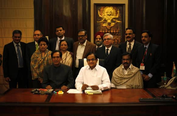 Finance Minister Palaniappan Chidambaram along with other finance ministry officials pose for photographs at his office in New Delhi.