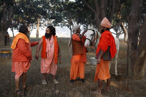 Hindu holy men belonging to the Ramta Panch group of the Juna Akhara or sect prepare a horse to be loaded onto a truck before leaving for Varanasi from the outskirts of Allahabad at the end of Maha Kumbh festival, in Allahabad.