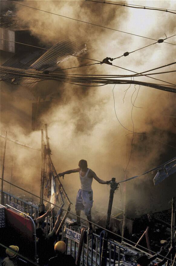 Smoke rises after a fire broke out early in the morning at an illegal six-story plastics market in Kolkata.
