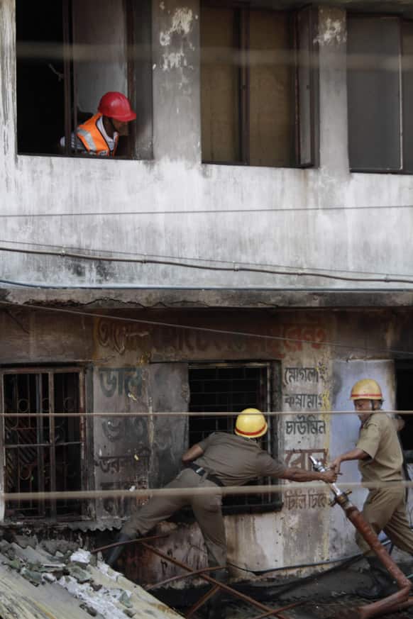 Firefighters try to douse a fire that broke out at an illegal six-story plastics market in Kolkata.