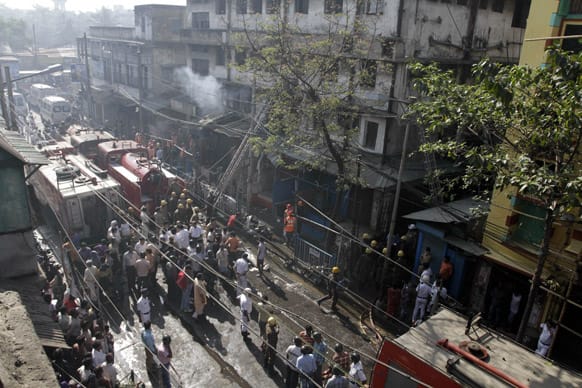Firefighters douse a fire after a fire broke out early morning at an illegal six-story plastics market in Kolkata.