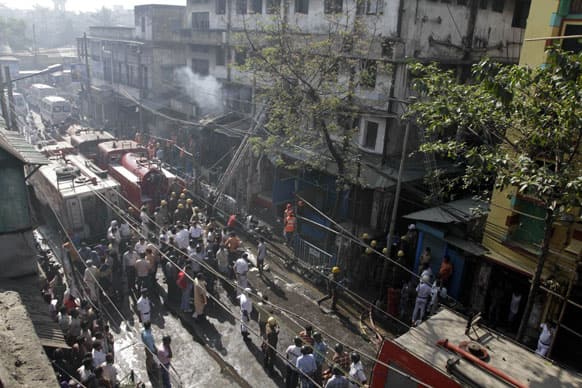 Firefighters douse a fire after a fire broke out early morning at an illegal six-story plastics market in Kolkata, India.