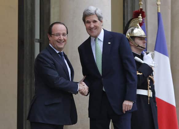 US Secretary of State John Kerry, right, is welcomed by France`s President Francois Hollande upon his arrival at the Elysee Palace, in Paris.