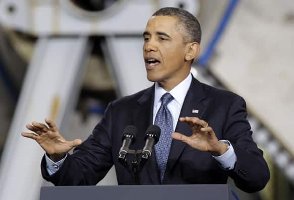 President Barack Obama gestures during a speech about automatic defense budget cuts, at Newport News Shipbuilding in Newport News, Va.
