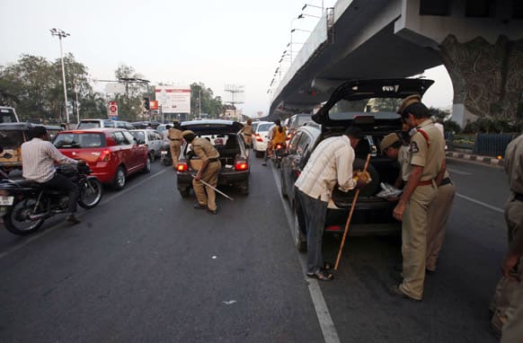 Policemen check belongings of motorists at a traffic signal after security was enhanced following Thursday’s dual bomb attacks in Hyderabad.