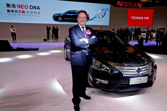 Andy Palmer, executive vice president of Nissan Motor Co., poses next to the new Nissan Teana after it was unveiled in Guangzhou in south China`s Guangdong province.