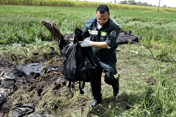 An Egyptian rescue worker collects remains near the scene of a balloon crash outside al-Dhabaa village, just west of the city of Luxor, south of Cairo. A hot air balloon flying over Egypt`s ancient city of Luxor caught fire and crashed into a sugar cane field on Tuesday, killing at least 18 foreign tourists.