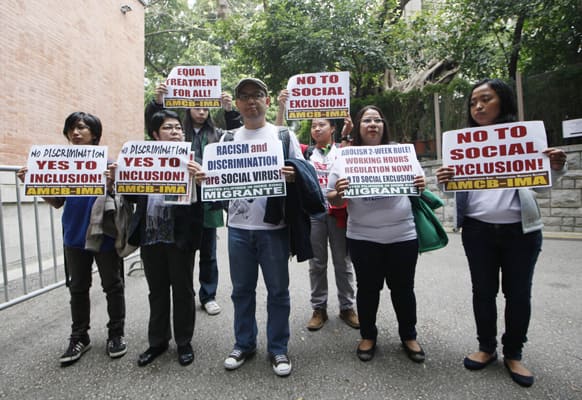 Eman C. Villanueva, secretary general of the United Filipinos in Hong Kong and other supporters of the Filipino migrants organizations hold placards outside the Court of Final Appeal in Hong Kong.