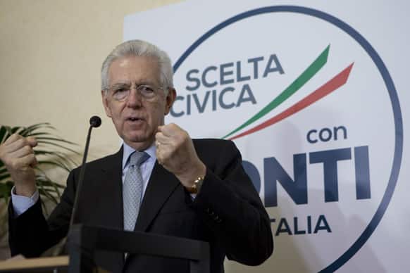 Italian Premier Mario Monti talks to the media during a press conference in his party headquarters, in Rome.