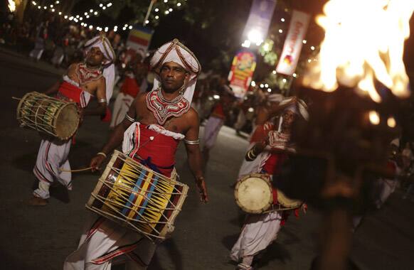 A Sri Lankan traditional drummers perform during the annual Buddhist temple festival of the Gangaramaya temple in Colombo, Sri Lanka.