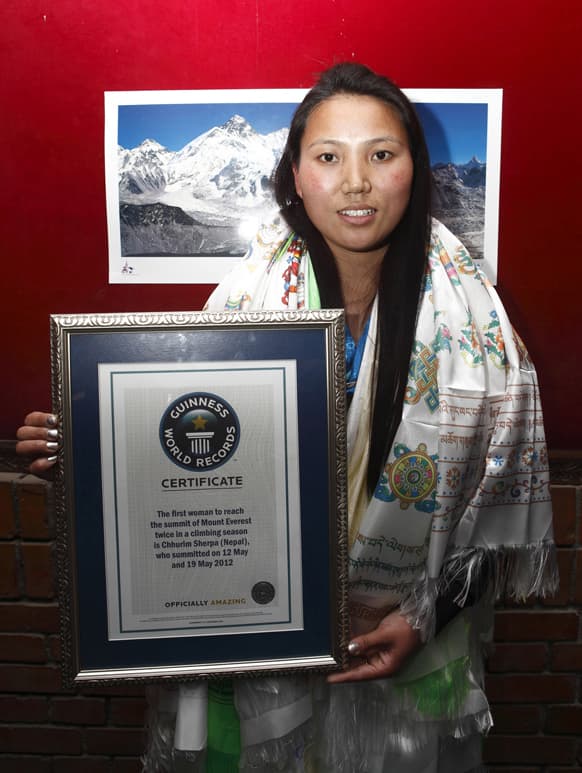 Nepalese woman mountaineer Chhurim who has been recognized by Guinness World Records for climbing Mount Everest twice in the same climbing season poses with the certificate issued to her in Katmandu.