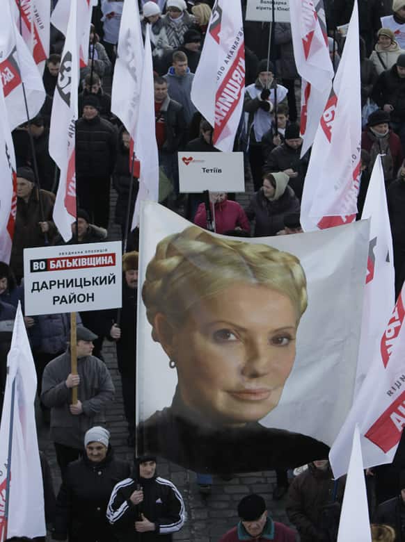 Supporters of former Ukrainian Prime Minister Yulia Tymoshenko wave a poster with her image as they take part in a rally in Kiev, Ukraine.