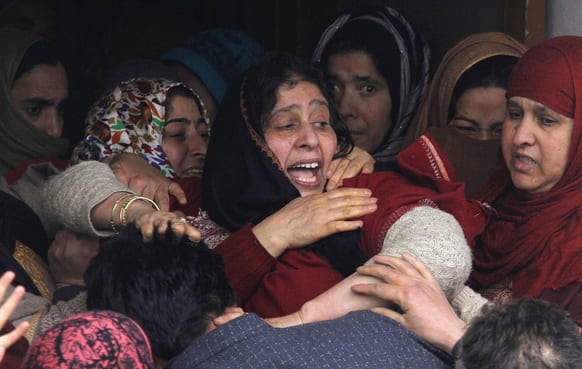 Relatives cry during the funeral procession of village headman Javaid Ahmad Wani in Kalantra Payeen village, some 50 kilometers (31 miles) north of Srinagar.
