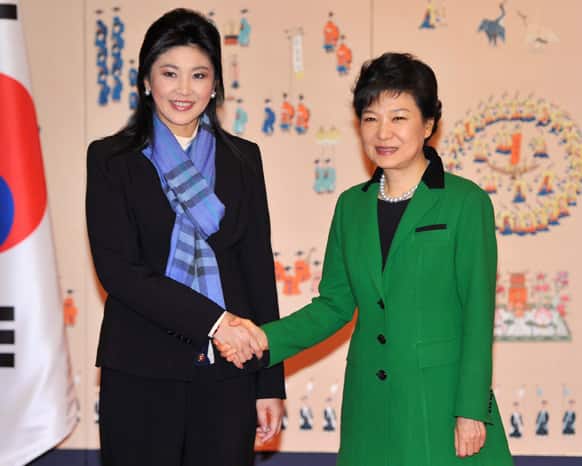 South Korea`s new president Park Geun-Hye, right, shakes hands with Thai Prime Minister Yingluck Shinawatra at the presidential Blue House in Seoul.