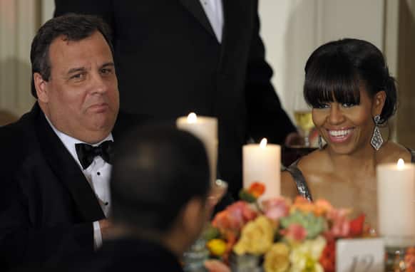 New Jersey Gov. Chris Christie sits next to first lady Michelle Obama as President Barack Obama welcomed the governors of the National Governors Association to the 2013 Governors’ Dinner at the White House in Washington.