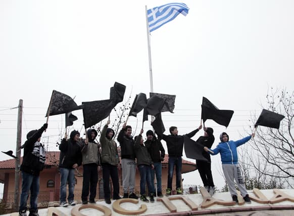 Youths hold black flags during a protest against the prospect of a gold mine and processing plant being built at Skouries, at the town of Megali Panagia located on the northern peninsula of Halkidiki Greece.