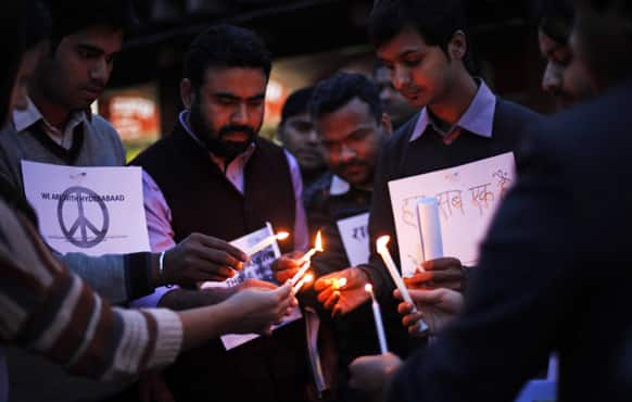 People light candles as they participate in a candle lit vigil to express solidarity with the Hyderabad blast victims and to spread the message of peace and harmony in New Delhi.