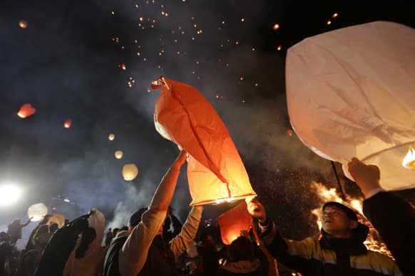 South Koreans release paper lanterns to celebrate the first full moon of the Lunar New Year, in Yongin, South Korea.