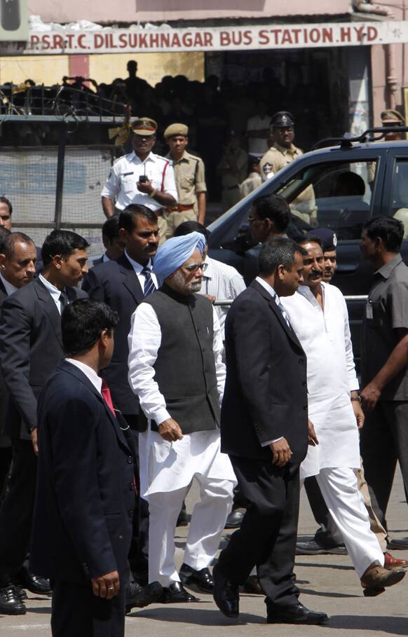 Prime Minister Manmohan Singh, blue turban, accompanied by Andhra Pradesh state Chief Minister N. Kiran Kumar Reddy, right in white, visits Dishuknagar bus station, one of the two sites of Thursday’s bomb attacks in Hyderabad.