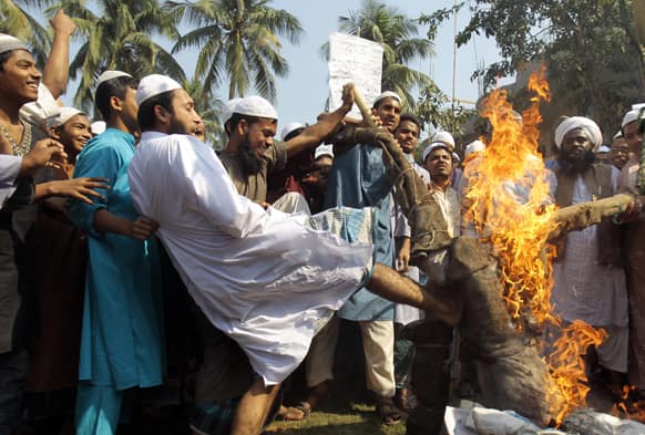 Activists of Islamic political parties denouncing war crimes trials linked to the country`s 1971 independence war, burn and kick an effigy of anti-Islamic bloggers inside an Islamic school during a nationwide strike in Dhaka, Bangladesh.