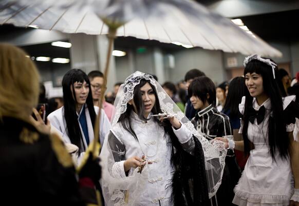 Chinese male cosplay enthusiasts dressed as female cartoon characters take part in the Animation and Comics Fair in Beijing.