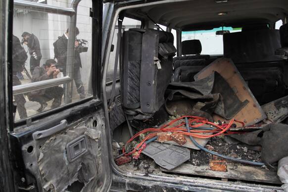 Explosive materials are seen in the back of a vehicle used by an insurgent at the site where he was shot to death in Kabul, Afghanistan.
