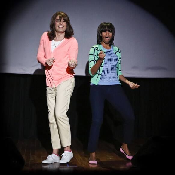 Host Jimmy Fallon dressed as a mom, left, dancing with first lady Michelle Obama during an appearance of