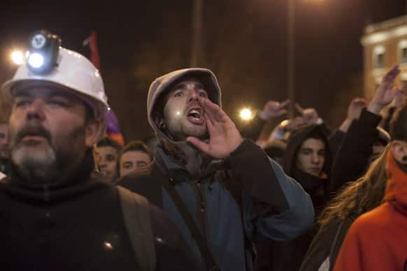 Demonstrators shout slogans against the government during a protest in Madrid, Spain. Thousands of people are marching on Spain`s parliament to protest austerity measures imposed by the government.