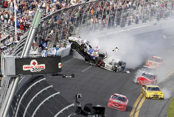 Kyle Larson`s car (32) gets airborne during a multi-car wreck on the final lap of the NASCAR Nationwide Series auto race, at Daytona International Speedway in Daytona Beach, Fla.