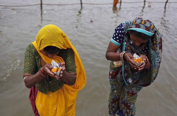 Hindu devotees perform rituals at the Sangam, confluence of Hindu holy rivers of Ganges, Yamuna and the mythical Saraswati, during the Maha Kumbh festival in Allahabad.