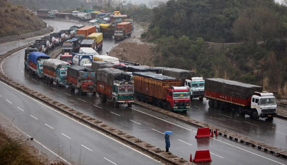 Stranded trucks wait for the Jammu-Srinagar highway to reopen on the outskirts of Jammu. A fresh spell of rain and snow has blocked the road linking Jammu and Srinagar.