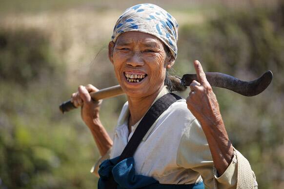 An elderly Khasi woman displays the indelible ink mark on her finger after casting her vote, outside a polling station in Marngar, in the northeastern Indian state of Meghalaya.