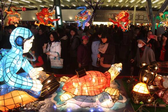 People look around lanterns on the eve of the Lantern Festival in Taipei. The Lantern Festival traditionally starts 15 days after the Chinese Lunar New Year and falls on Feb. 24 this year.