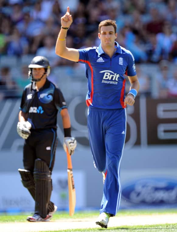 England`s Steven Finn celebrates dismissing New Zealand`s Hamish Rutherford for 2 in the third one day international cricket match at Eden Park in Auckland, New Zealand.
