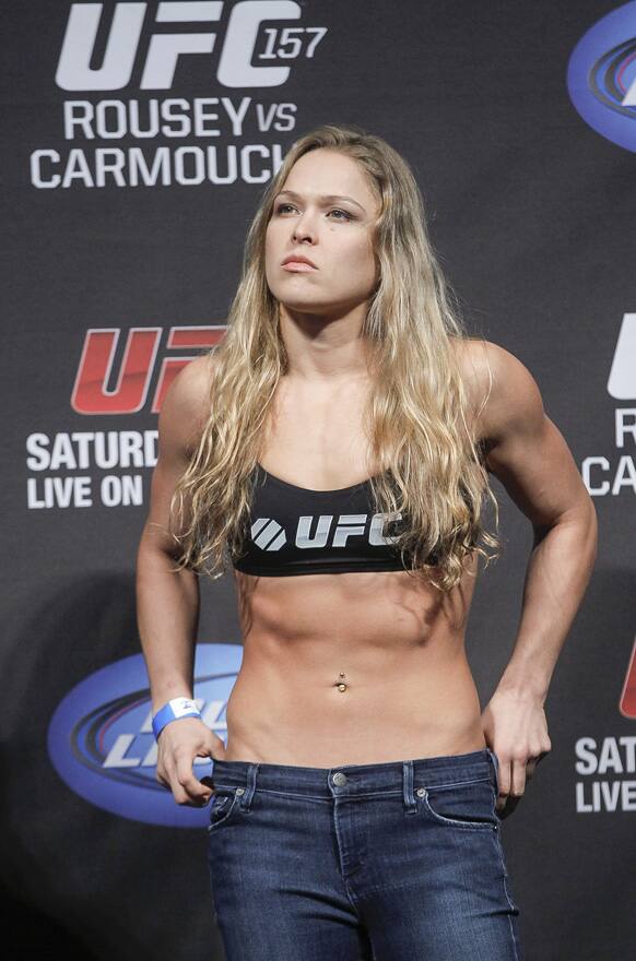 Mixed martial arts fighter UFC bantamweight champion, Ronda Rousey poses during a weight in at the Honda Center in Anaheim, Calif.