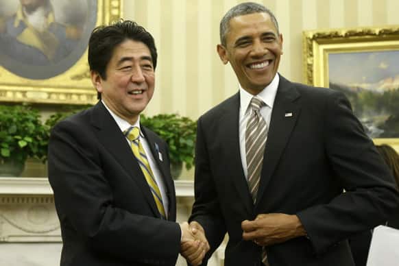 President Barack Obama shakes hands with Japan`s Prime Minister Shinzo Abe in the Oval Office of the White House in Washington.